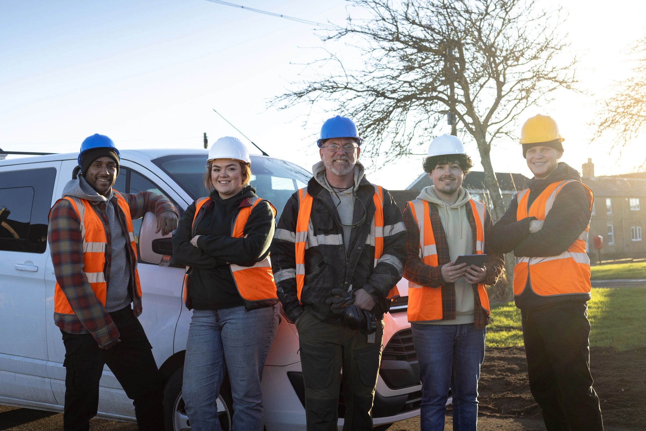 Professional construction crew standing together at a worksite