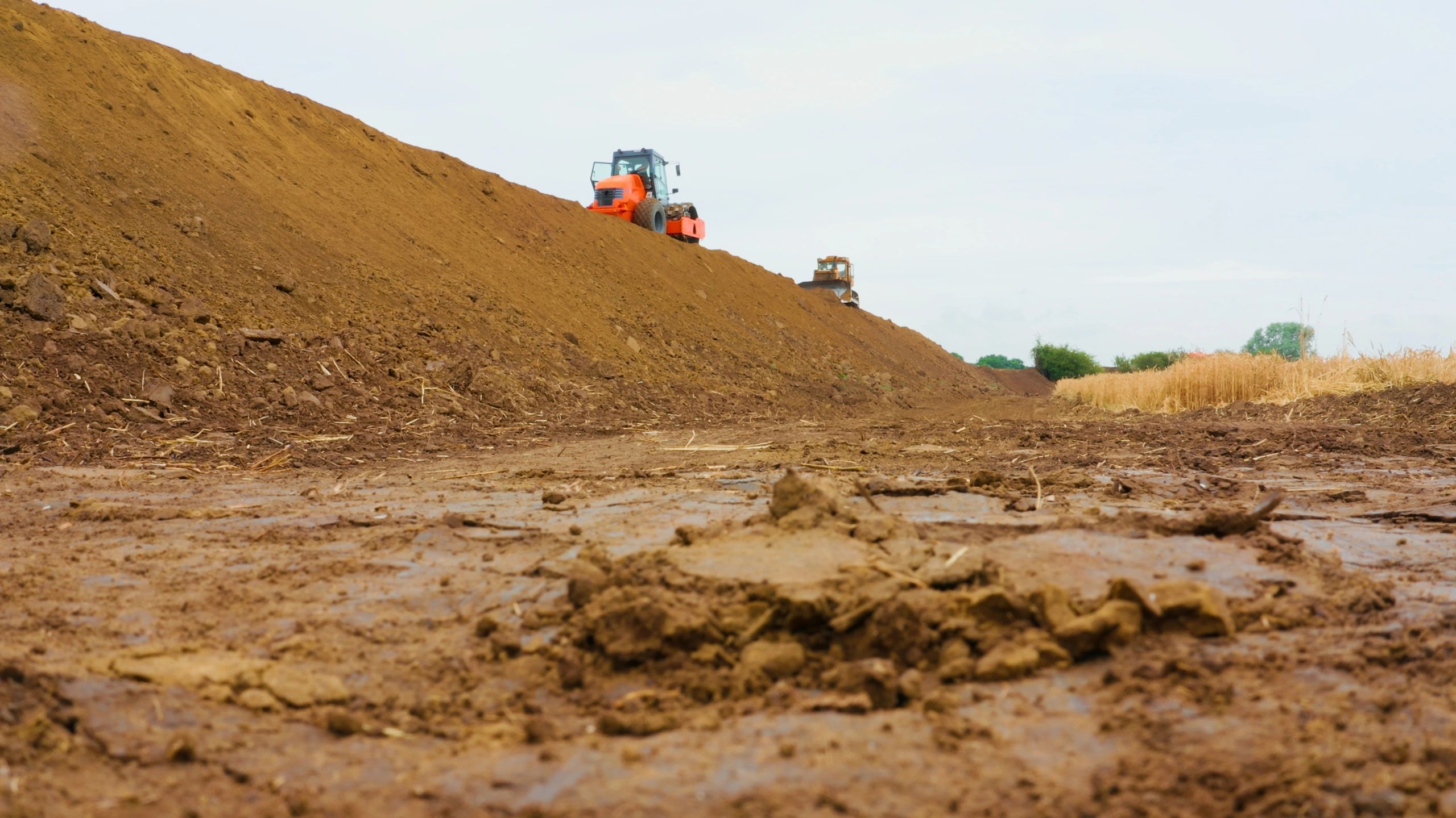 Heavy equipment shaping and grading a construction site